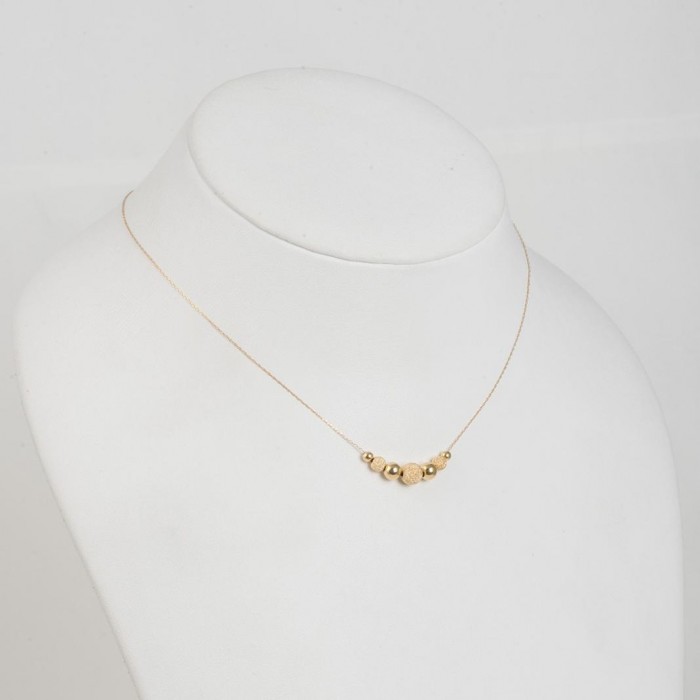 Halskette aus 14 K Gelbgold mit glasierten Kugeln und glatten Kugeln