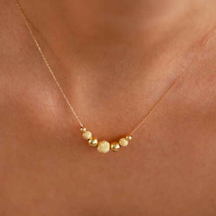 Halskette aus 14 K Gelbgold mit glasierten Kugeln und glatten Kugeln